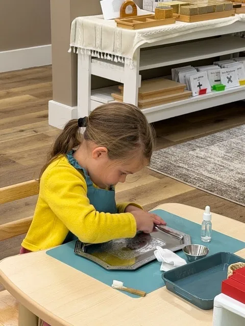 Girl doing a practical life polishing activity