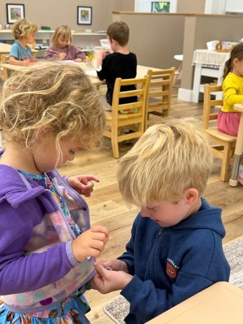 Two children working together at a classroom table