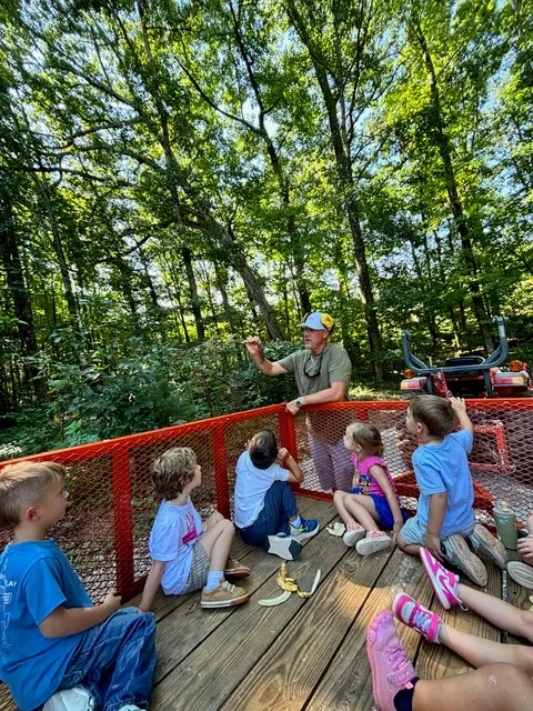 Children gathered on the deck for an outdoor lesson