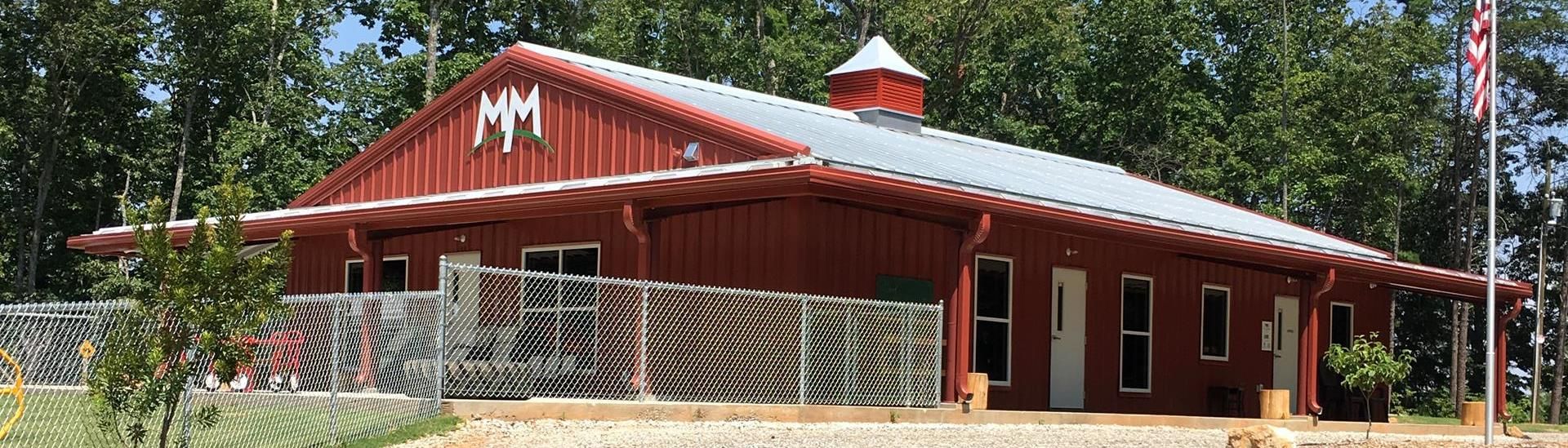 The Mountain Montessori school building surrounded by trees